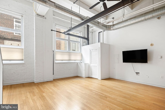 810 N Hancock St Unit 2, Philadelphia, PA 19123 - basement with brick wall, wood finished floors, and ceiling fan