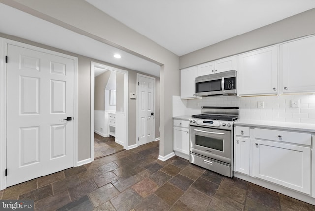 8 Railroad Pl, Pennington, NJ 08534 - kitchen featuring appliances with stainless steel finishes, light countertops, backsplash, white cabinetry, and stone tile floors