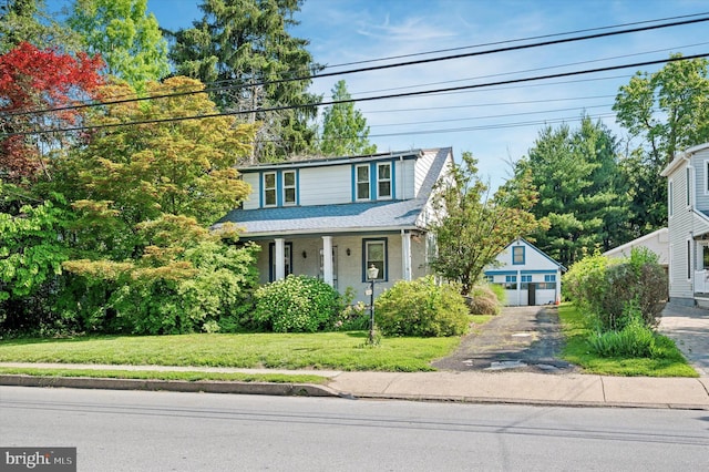 1865 Marshall, Norristown, PA 19403 - traditional-style house with a front yard, an outdoor structure, a detached garage, a porch, and roof with shingles