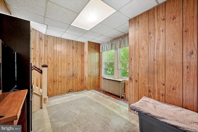 1865 Marshall, Norristown, PA 19403 - empty room with radiator heating unit, wooden walls, carpet, and a paneled ceiling