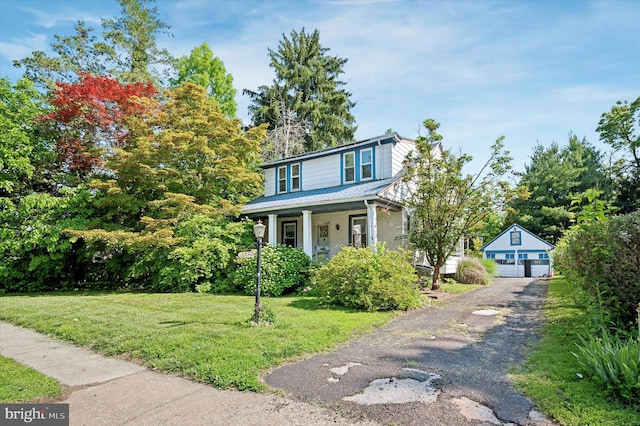1865 Marshall, Norristown, PA 19403 - view of front of property featuring a porch, a front yard, a garage, and an outbuilding