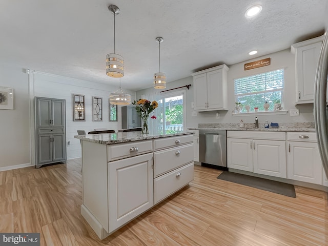 26055 Prospect Hill Rd, Mechanicsville, MD 20659 - kitchen with stainless steel dishwasher, a kitchen island, a textured ceiling, white cabinets, and light wood-type flooring