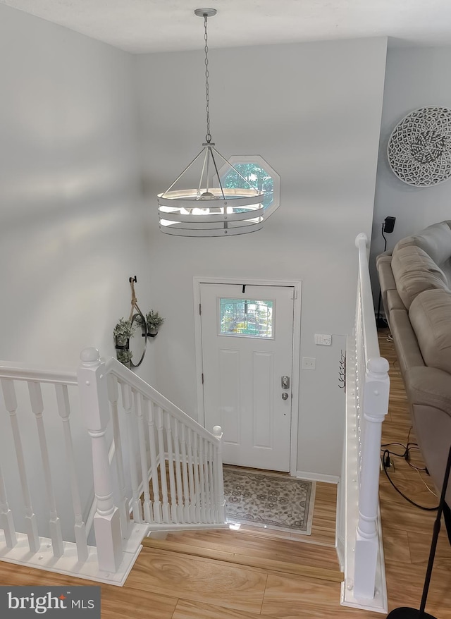 26055 Prospect Hill Rd, Mechanicsville, MD 20659 - entryway with light wood-style floors, a chandelier, a towering ceiling, and baseboards