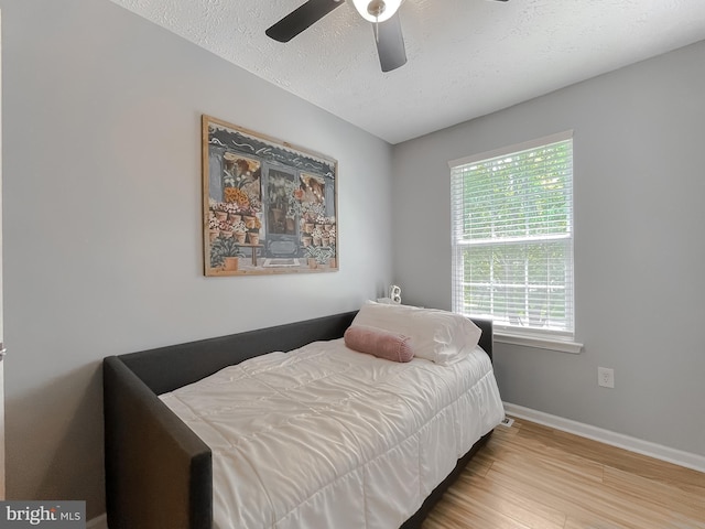 26055 Prospect Hill Rd, Mechanicsville, MD 20659 - bedroom with wood finished floors, baseboards, a ceiling fan, and a textured ceiling