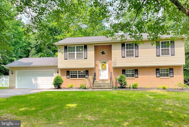 26055 Prospect Hill Rd, Mechanicsville, MD 20659 - split foyer home with an attached garage, a front lawn, driveway, and brick siding