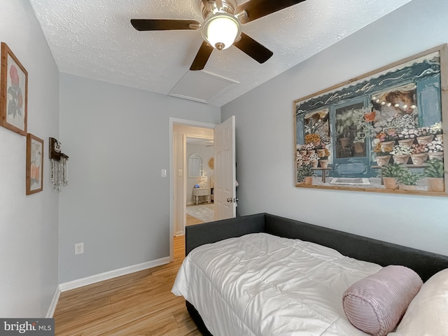 26055 Prospect Hill Rd, Mechanicsville, MD 20659 - bedroom with wood finished floors, attic access, baseboards, ceiling fan, and a textured ceiling