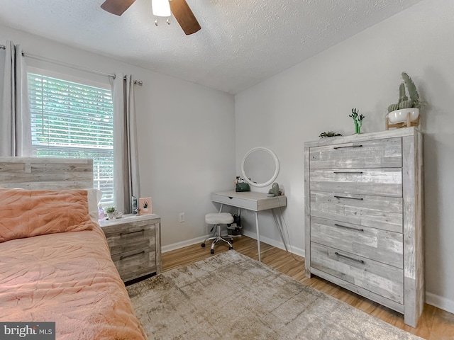 26055 Prospect Hill Rd, Mechanicsville, MD 20659 - bedroom with wood finished floors, a textured ceiling, baseboards, and a ceiling fan