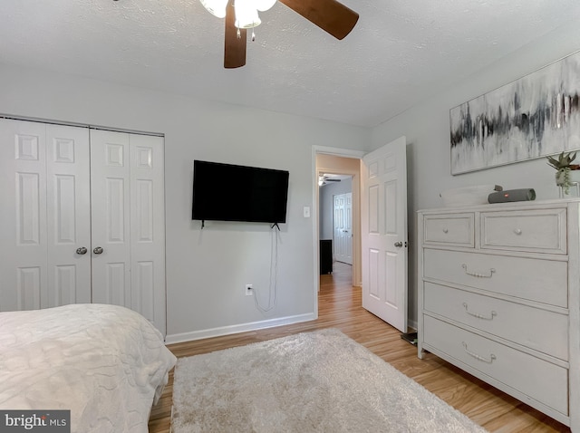 26055 Prospect Hill Rd, Mechanicsville, MD 20659 - bedroom with light wood-type flooring, a closet, baseboards, a textured ceiling, and ceiling fan