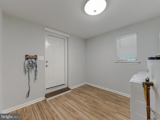 26055 Prospect Hill Rd, Mechanicsville, MD 20659 - laundry area with light wood finished floors, baseboards, independent washer and dryer, and water heater