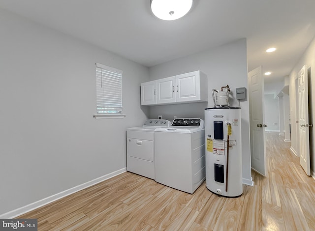 26055 Prospect Hill Rd, Mechanicsville, MD 20659 - washroom with electric water heater, cabinet space, independent washer and dryer, light wood finished floors, and baseboards