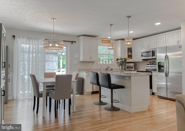 26055 Prospect Hill Rd, Mechanicsville, MD 20659 - kitchen with stainless steel appliances, plenty of natural light, white cabinets, light stone countertops, and recessed lighting
