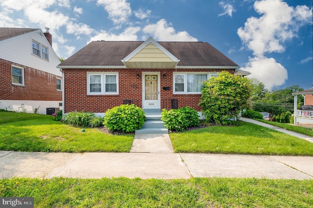 328 W Summit St, Mohnton, PA 19540 - bungalow-style home with brick siding, a front yard, central AC, and roof with shingles