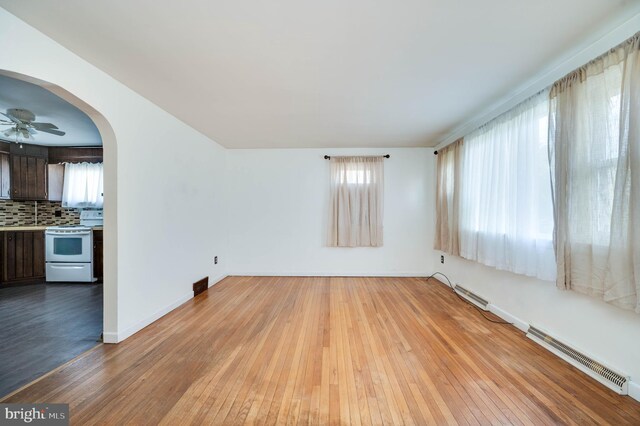 328 W Summit St, Mohnton, PA 19540 - unfurnished room featuring light wood finished floors, arched walkways, baseboards, and ceiling fan