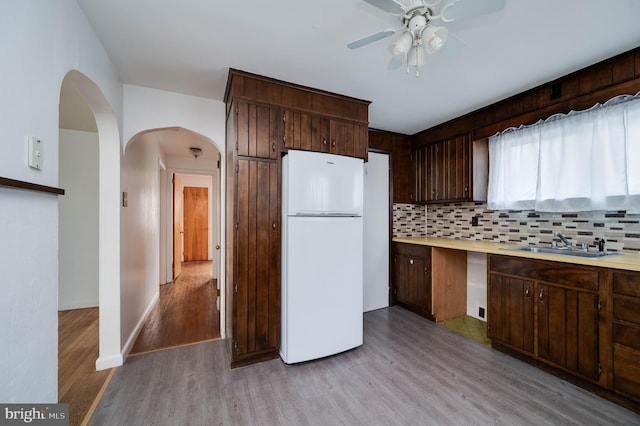 328 W Summit St, Mohnton, PA 19540 - kitchen with freestanding refrigerator, a sink, a ceiling fan, light wood-type flooring, and dark brown cabinets