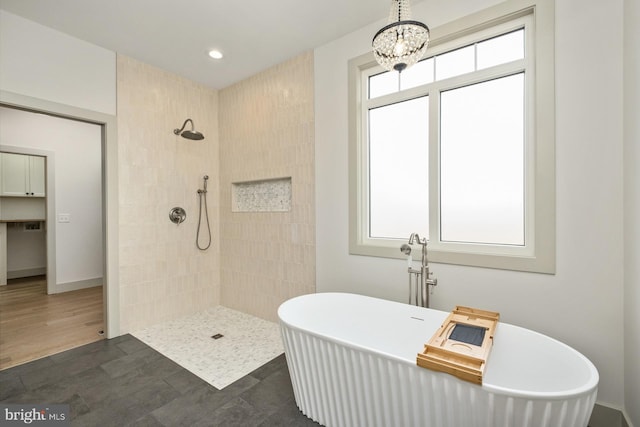 135 Radnor Ct, Rockingham, VA 22801 - bathroom featuring tiled shower, a soaking tub, a chandelier, recessed lighting, and baseboards