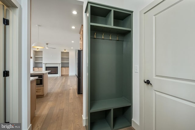 135 Radnor Ct, Rockingham, VA 22801 - mudroom featuring light wood-style flooring, a ceiling fan, a fireplace, and recessed lighting