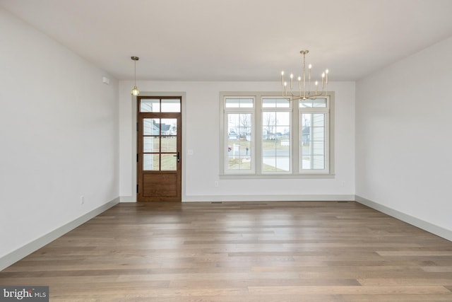 135 Radnor Ct, Rockingham, VA 22801 - unfurnished dining area with a chandelier, wood finished floors, and baseboards