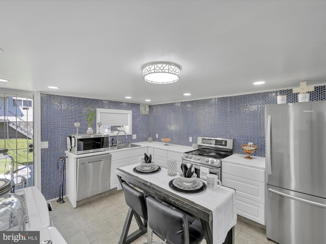 220 Fisher Ave, Coaldale, PA 18218 - kitchen featuring stainless steel appliances, a sink, light countertops, white cabinets, and light tile patterned flooring