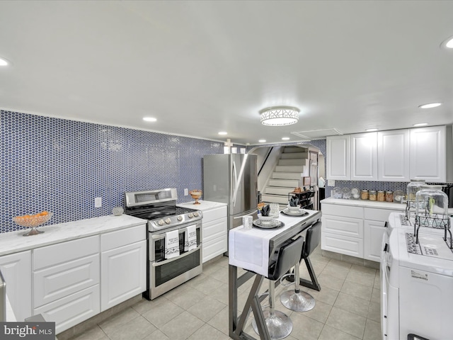 220 Fisher Ave, Coaldale, PA 18218 - kitchen featuring appliances with stainless steel finishes, light countertops, and white cabinetry