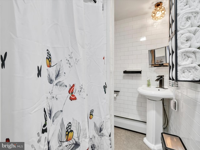 220 Fisher Ave, Coaldale, PA 18218 - bathroom with a baseboard heating unit, tile patterned floors, a sink, tile walls, and a shower with curtain