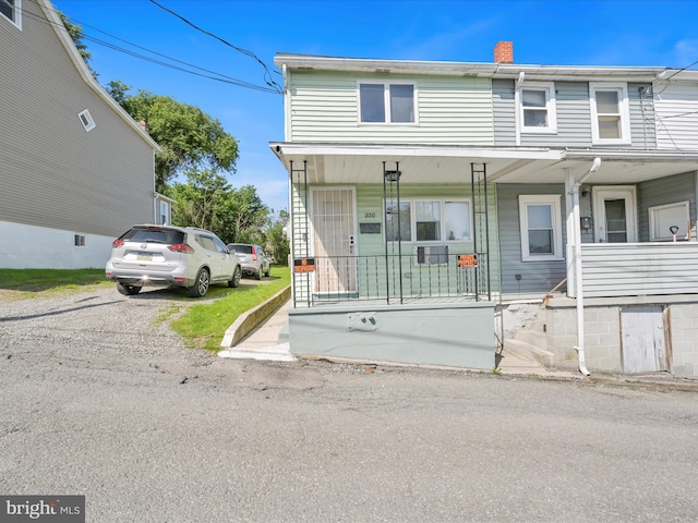 220 Fisher Ave, Coaldale, PA 18218 - townhome / multi-family property with covered porch and a chimney