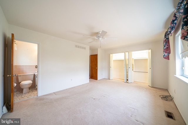 7911 Farnsworth St, Philadelphia, PA 19152 - unfurnished bedroom with carpet flooring, tile walls, ensuite bath, and a ceiling fan