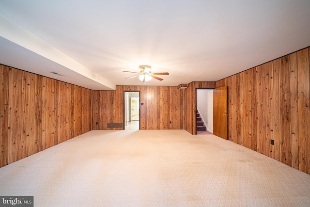 7911 Farnsworth St, Philadelphia, PA 19152 - empty room featuring a ceiling fan, wooden walls, carpet flooring, and stairs