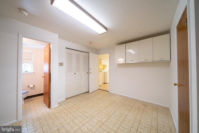 7911 Farnsworth St, Philadelphia, PA 19152 - unfurnished bedroom featuring baseboards, washing machine and dryer, light flooring, a closet, and ensuite bathroom