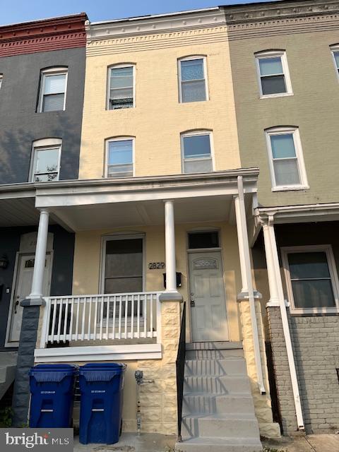 2829 Hampden Ave, Baltimore, MD 21211 - view of front facade with a porch and brick siding