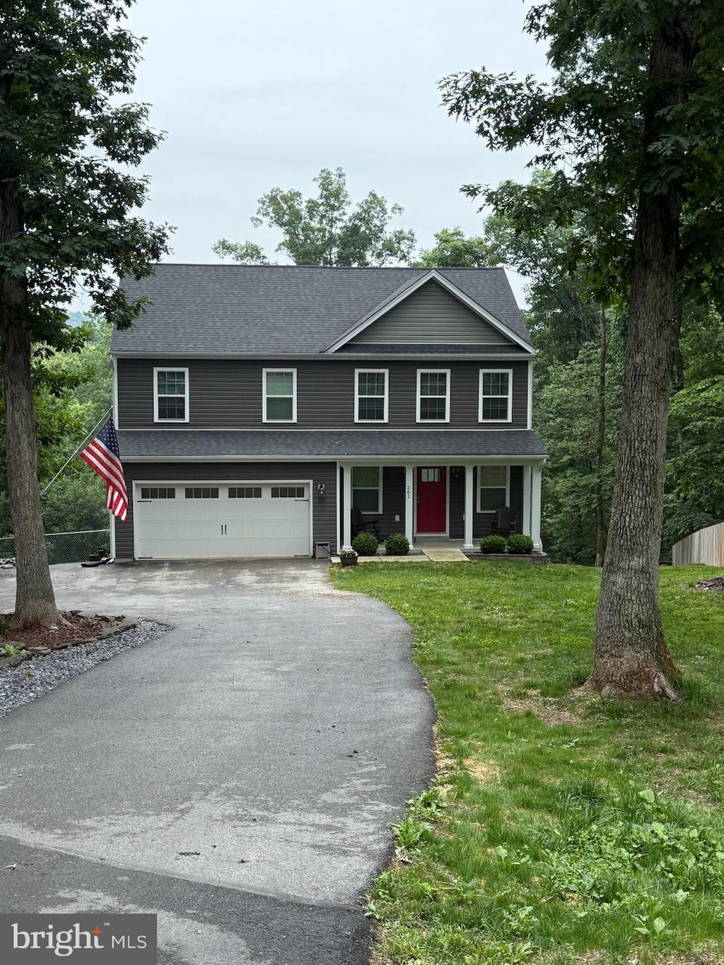 261 Cone Ct, Martinsburg, WV 25405 - view of front of house featuring asphalt driveway, a porch, an attached garage, and a front lawn