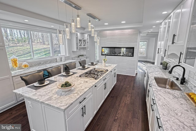 1637 Cold Bottom Rd, Sparks Glencoe, MD 21152 - kitchen featuring a sink, stainless steel gas cooktop, dark wood-style floors, white cabinets, and light stone counters