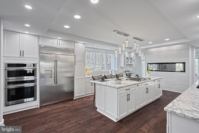 1637 Cold Bottom Rd, Sparks Glencoe, MD 21152 - kitchen with stainless steel appliances, white cabinetry, dark wood-style flooring, light stone countertops, and recessed lighting