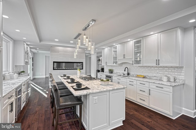 1637 Cold Bottom Rd, Sparks Glencoe, MD 21152 - kitchen with white cabinetry, dark wood-style flooring, a glass covered fireplace, and recessed lighting