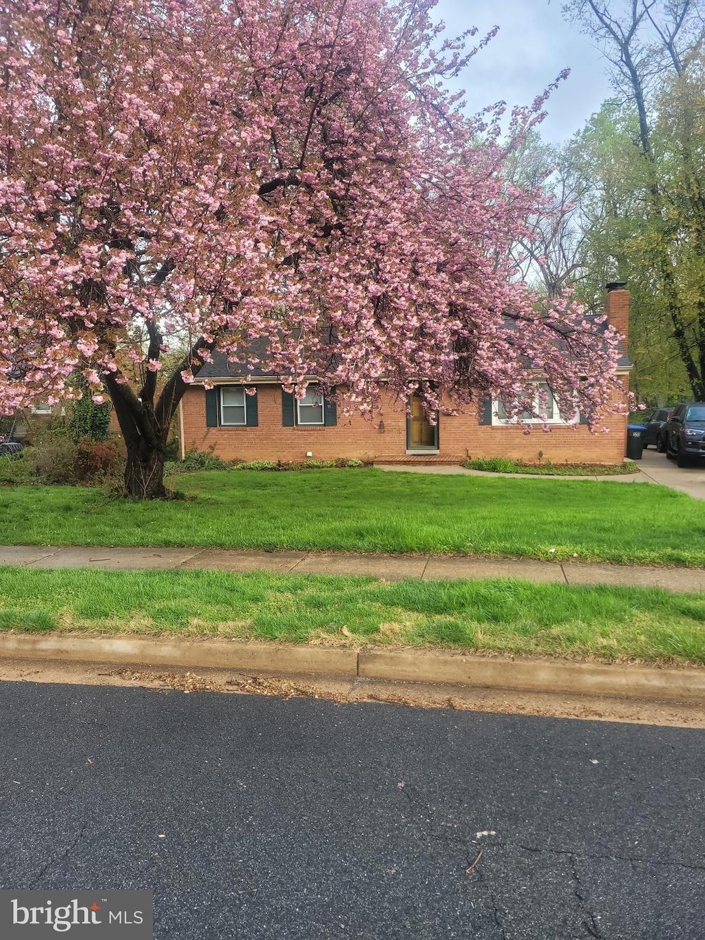 7632 Webbwood Ct, Springfield, VA 22151 - view of front of home with a front lawn, a chimney, and brick siding