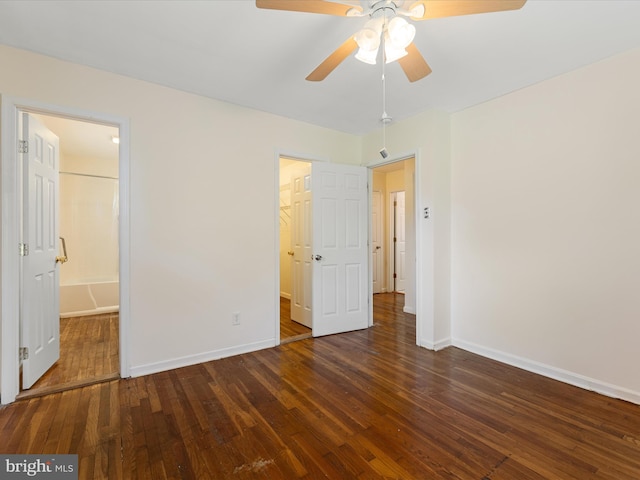 310 Bethel Rd, Paw Paw, WV 25434 - unfurnished bedroom with a spacious closet, wood-type flooring, baseboards, and a ceiling fan