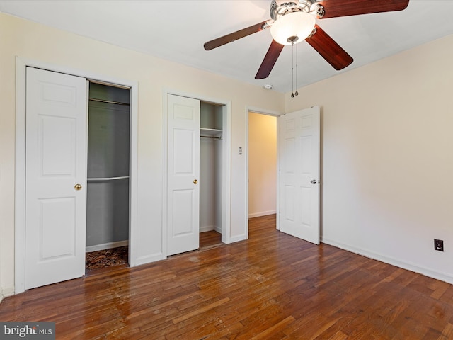 310 Bethel Rd, Paw Paw, WV 25434 - unfurnished bedroom with two closets, wood finished floors, and baseboards