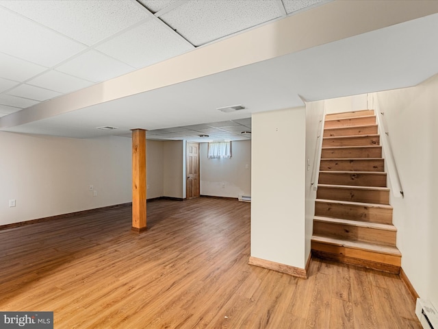 310 Bethel Rd, Paw Paw, WV 25434 - finished basement with a drop ceiling, stairs, a baseboard heating unit, light wood finished floors, and baseboards