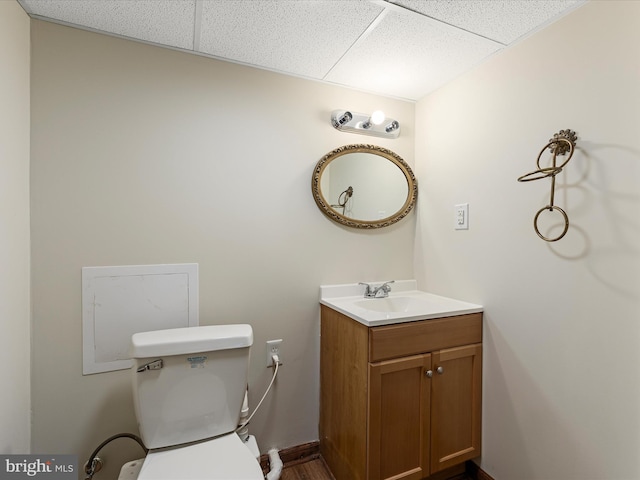310 Bethel Rd, Paw Paw, WV 25434 - bathroom with vanity, a drop ceiling, and toilet