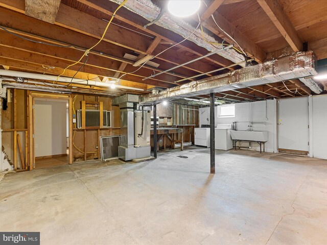310 Bethel Rd, Paw Paw, WV 25434 - basement with heating unit, washer and dryer, and a sink