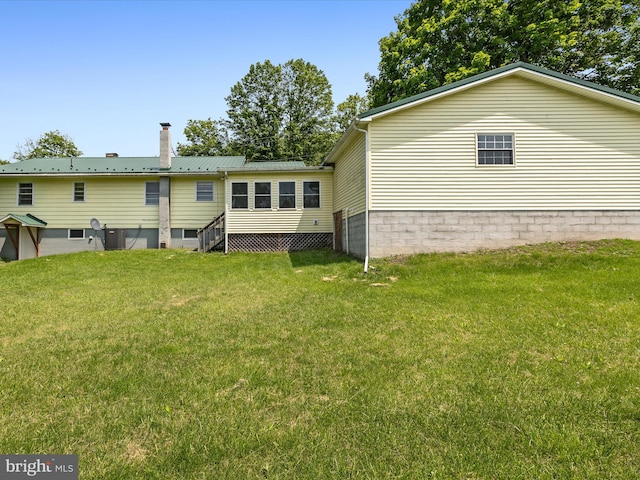 310 Bethel Rd, Paw Paw, WV 25434 - rear view of house featuring a yard, a chimney, and metal roof