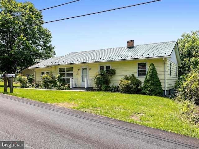 310 Bethel Rd, Paw Paw, WV 25434 - view of front facade with a chimney, a front yard, and metal roof