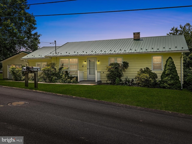 310 Bethel Rd, Paw Paw, WV 25434 - view of front of house featuring a chimney, a front yard, and metal roof