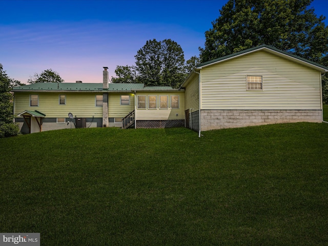 310 Bethel Rd, Paw Paw, WV 25434 - back of house with a chimney, a lawn, and metal roof