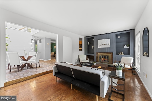 11866 S Lakes Ct, Reston, VA 20191 - living room with a glass covered fireplace, built in features, and hardwood / wood-style flooring