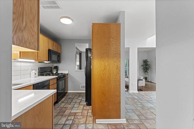 11866 S Lakes Ct, Reston, VA 20191 - kitchen with black appliances, stone tile flooring, light countertops, and decorative backsplash