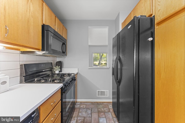 11866 S Lakes Ct, Reston, VA 20191 - kitchen featuring black appliances, tasteful backsplash, light countertops, stone finish flooring, and brown cabinetry