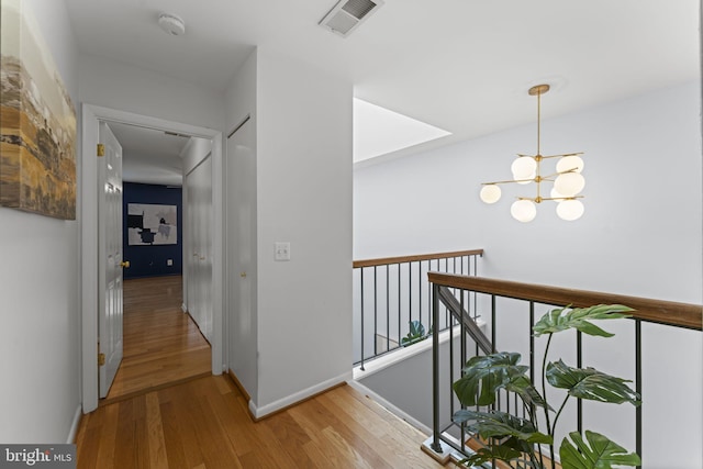 11866 S Lakes Ct, Reston, VA 20191 - corridor with wood finished floors and a chandelier