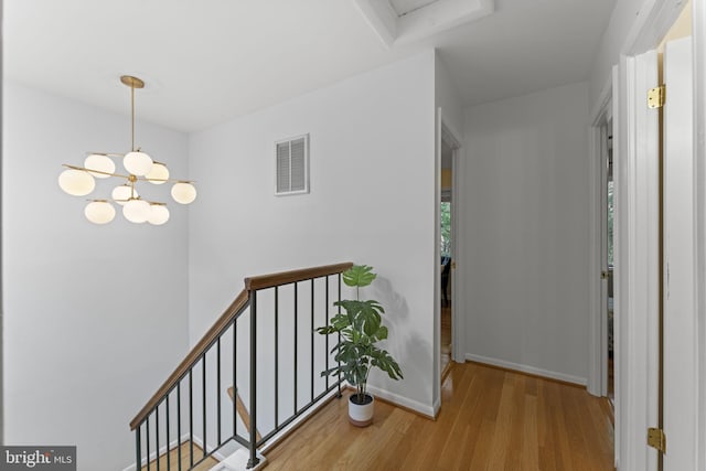11866 S Lakes Ct, Reston, VA 20191 - corridor featuring wood finished floors, an upstairs landing, and a chandelier