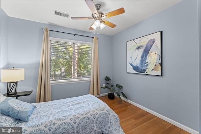 11866 S Lakes Ct, Reston, VA 20191 - bedroom with wood finished floors and a ceiling fan