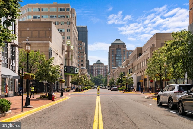 11866 S Lakes Ct, Reston, VA 20191 - view of asphalt road with street lights, a city view, curbs, and sidewalks